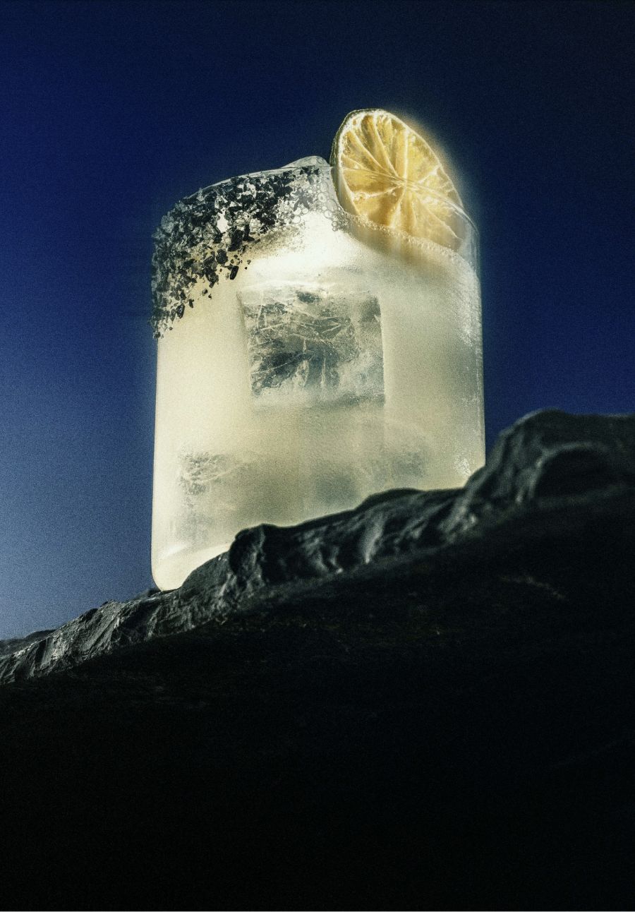 glass with ice and lemon on cliff