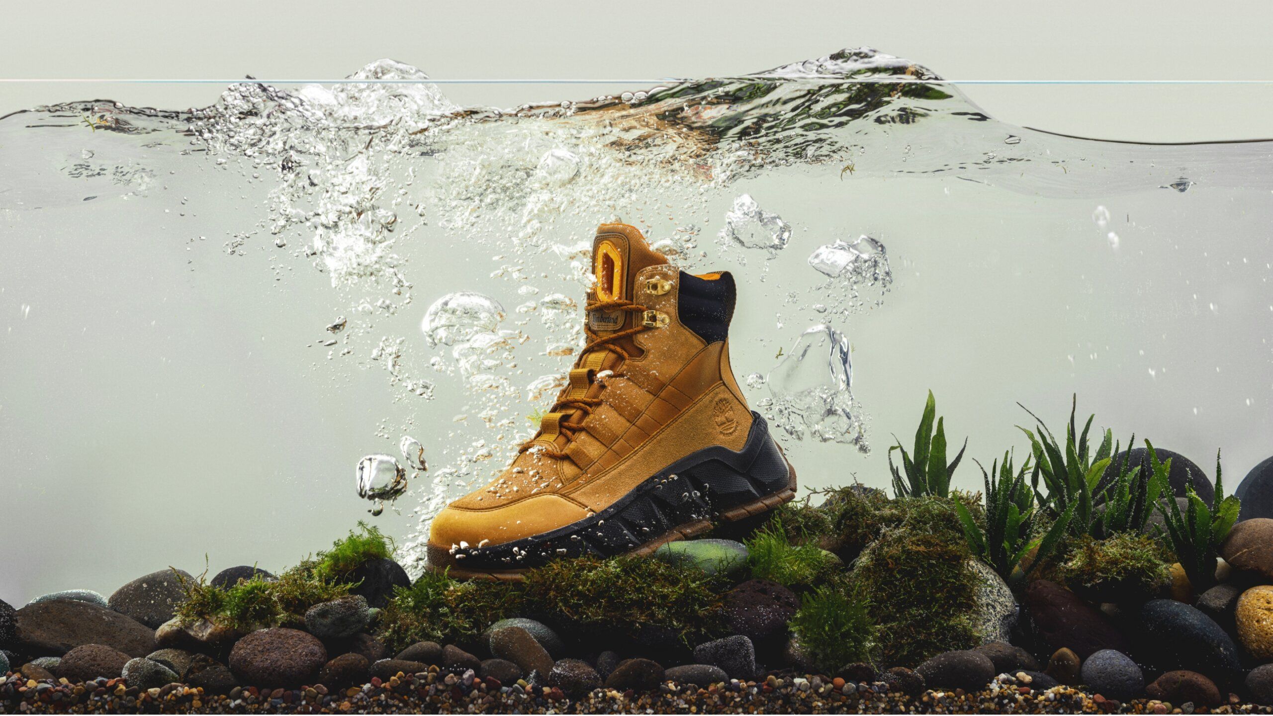 Timberland Greenstride Turbo TBL waterproof boot in water tank with rocks and plants at bottom