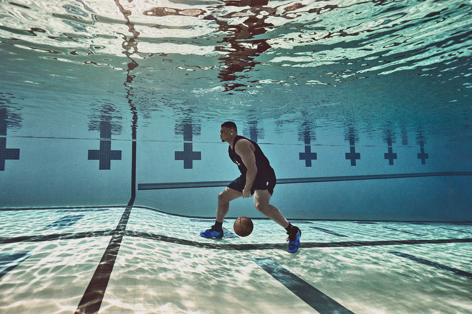 Zion Williamson dribbling basketball underwater in swimming pool