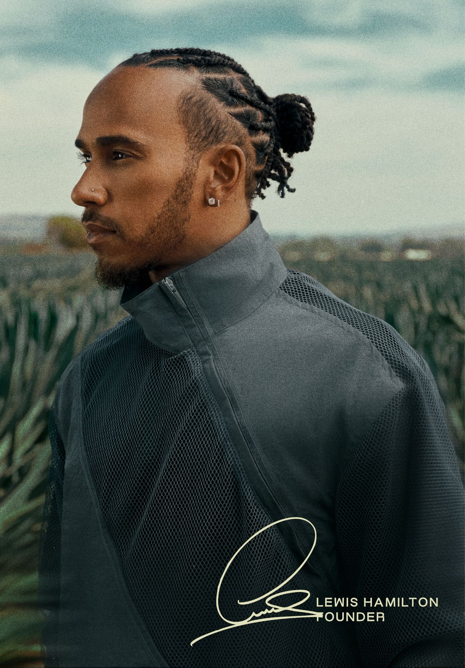 Lewis Hamilton, founder, in profile standing in agave field