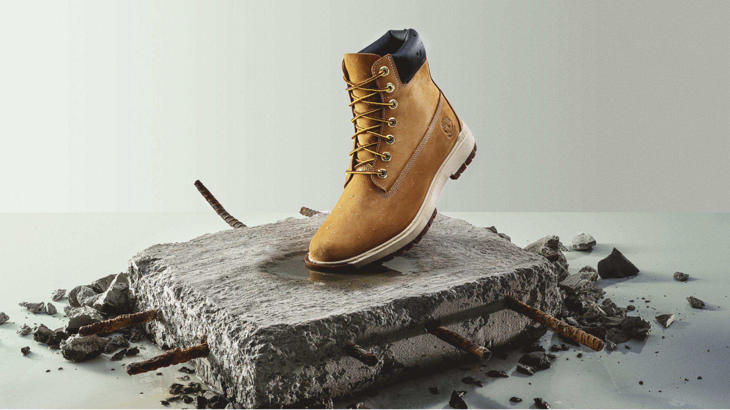 timberland boot on piece of concrete with re-bar