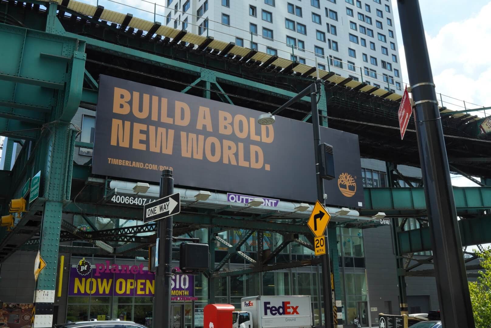 Timberland Build a Bold New World Billboard on city subway bridge
