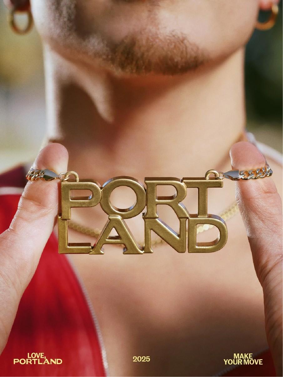 Close-up of a person holding a gold necklace that spells "PORTLAND." The words "LOVE PORTLAND," "2025," and "MAKE YOUR MOVE" appear at the bottom of the image.