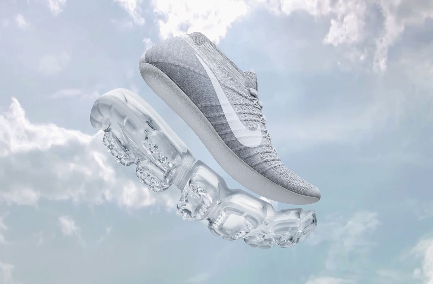 rendering of nike running shoe with air sole detached from bottom. Background is sky with fluffy clouds