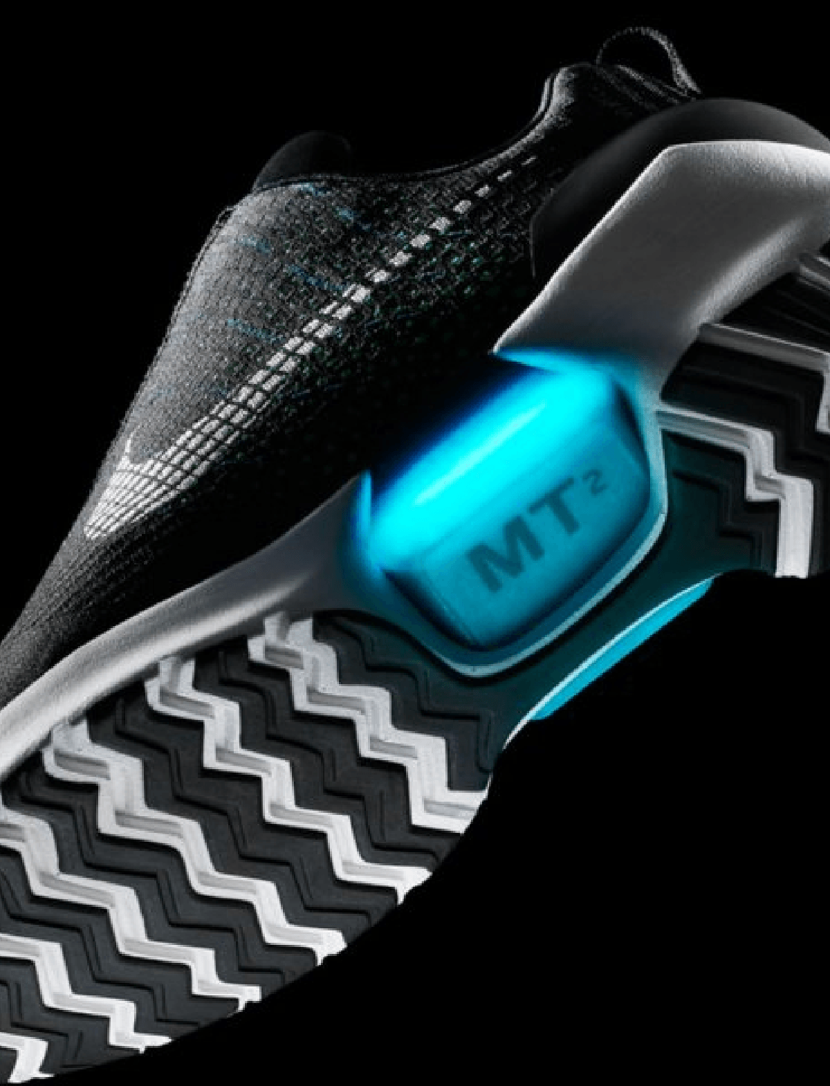 bottom view of Nike Hyper Adapt sneaker showing zig zig pattern tread and glowing MT2 arch