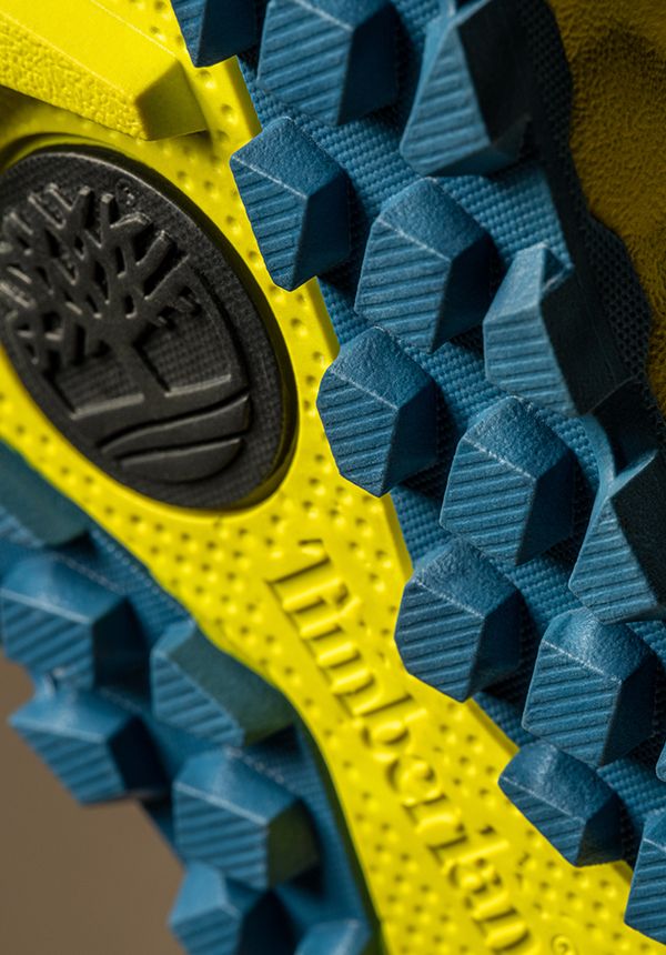 Close up of blue and yellow sole of Timberland Solar Ridge Greenstride boot