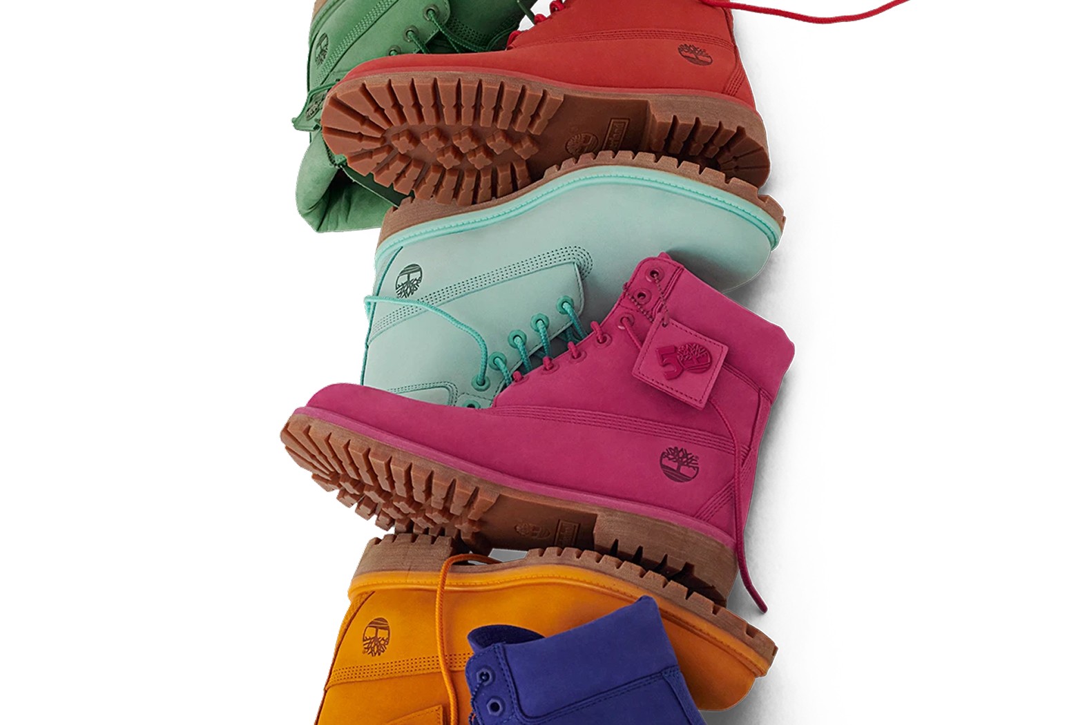 Six Timberland boots in different colors—green, red, teal, pink, orange, and blue—are stacked diagonally on a white background.