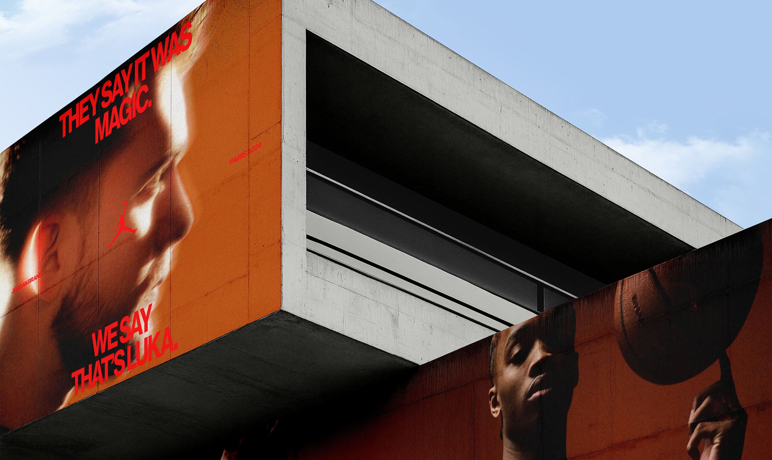 A modern concrete building features large murals of two basketball players and bold red text reading, "THEY SAY IT WAS MAGIC. WE SAY THAT'S LUKA.