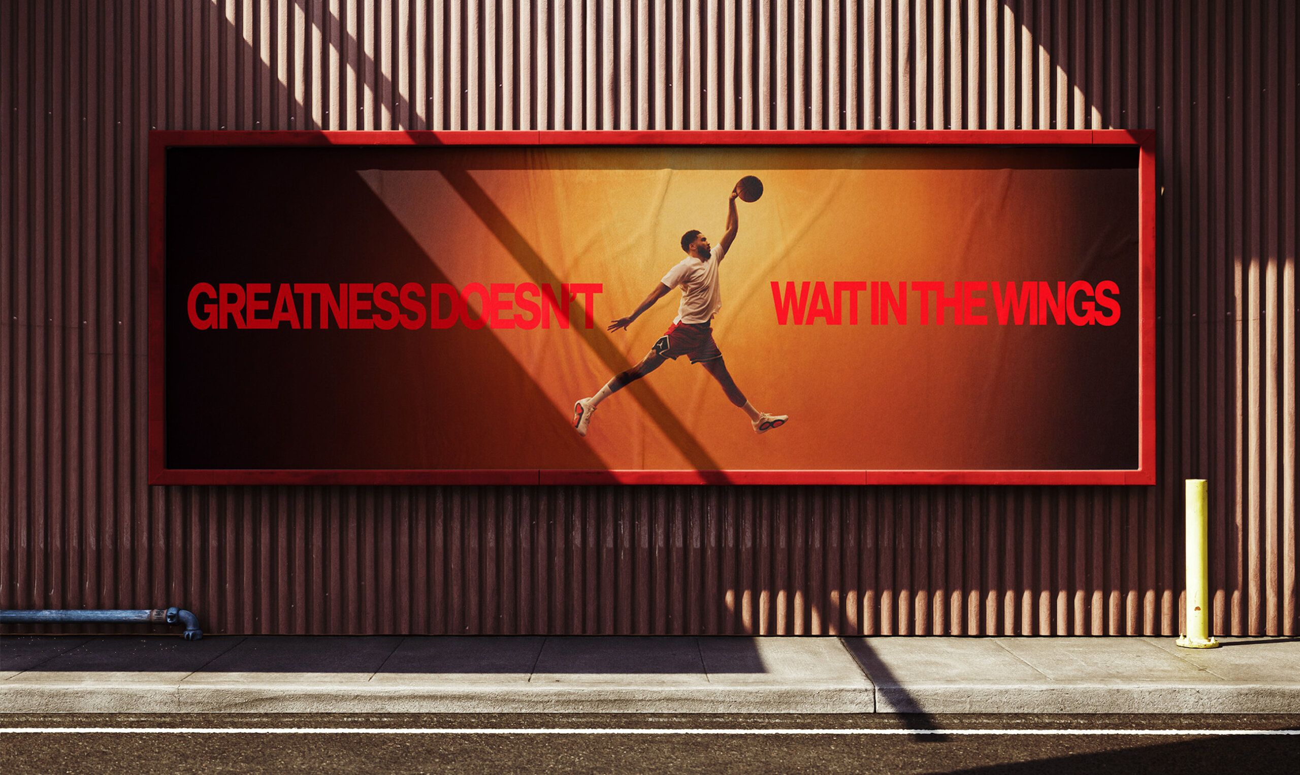 A billboard shows a person jumping to dunk a basketball with the text "GREATNESS DOESN'T WAIT IN THE WINGS" in bold red letters.