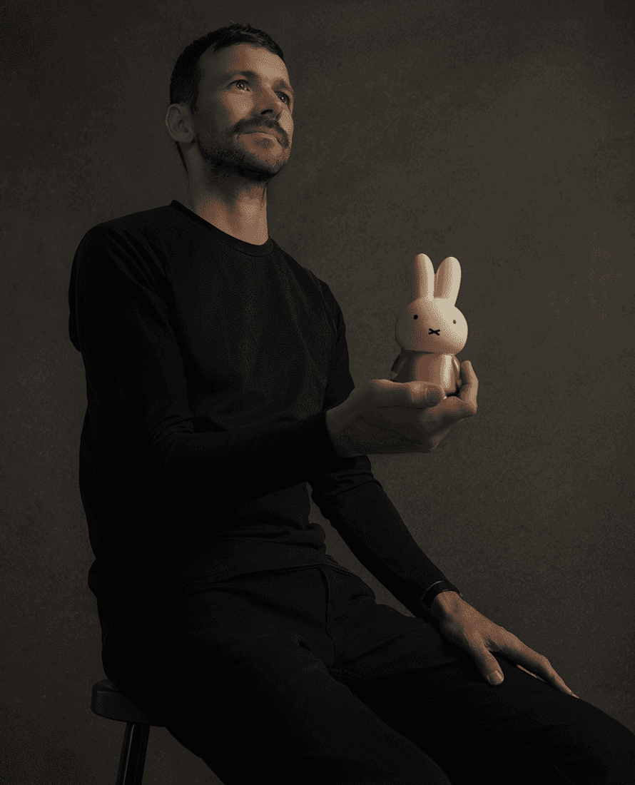 Bas sitting holding rabbit toy