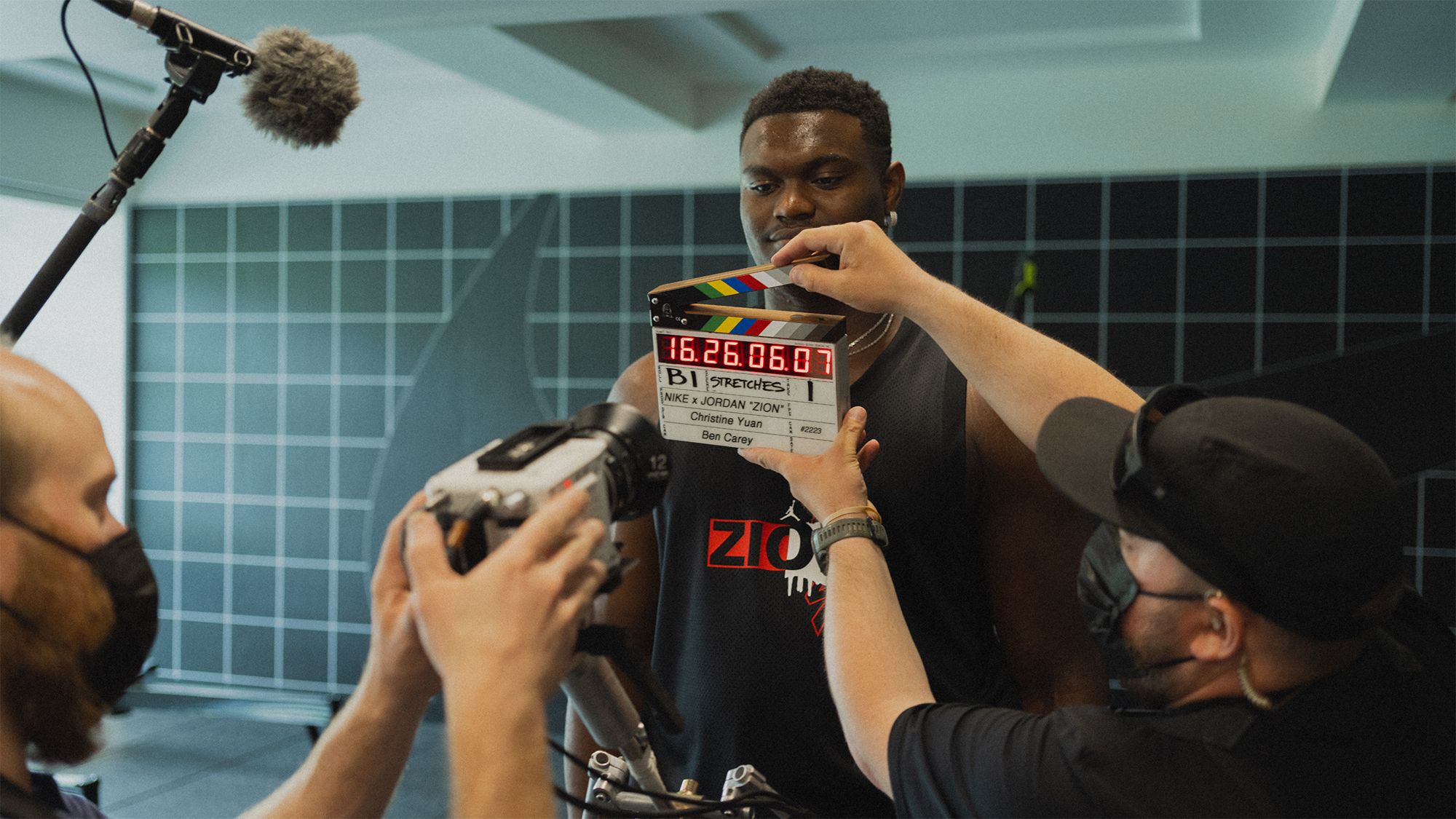 Zion getting ready to shoot with clapperboard and boom microphone