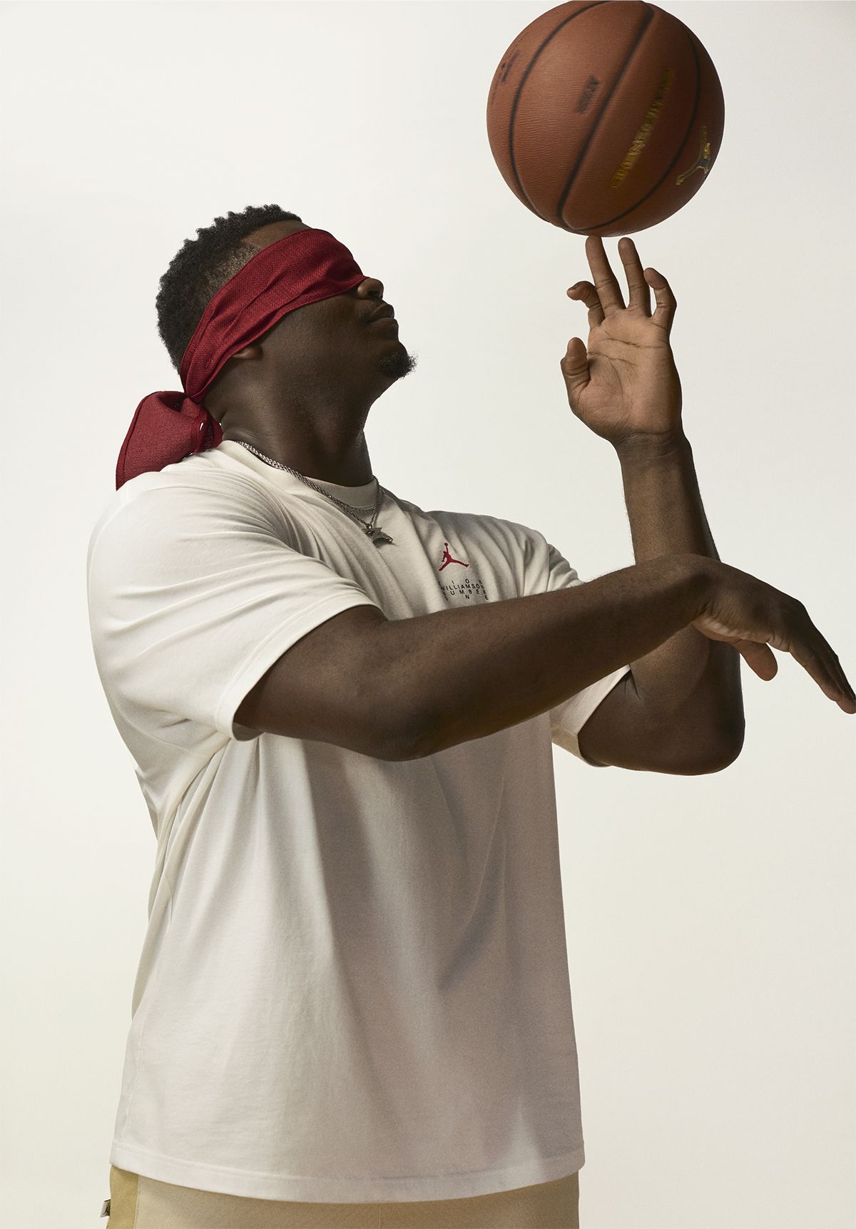 Zion spinning basketball on his finger while blindfolded