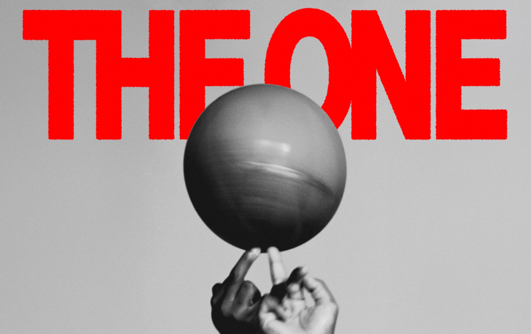 A red "THE ONE" text appears above a grayscale hand spinning a basketball on one finger against a plain background.