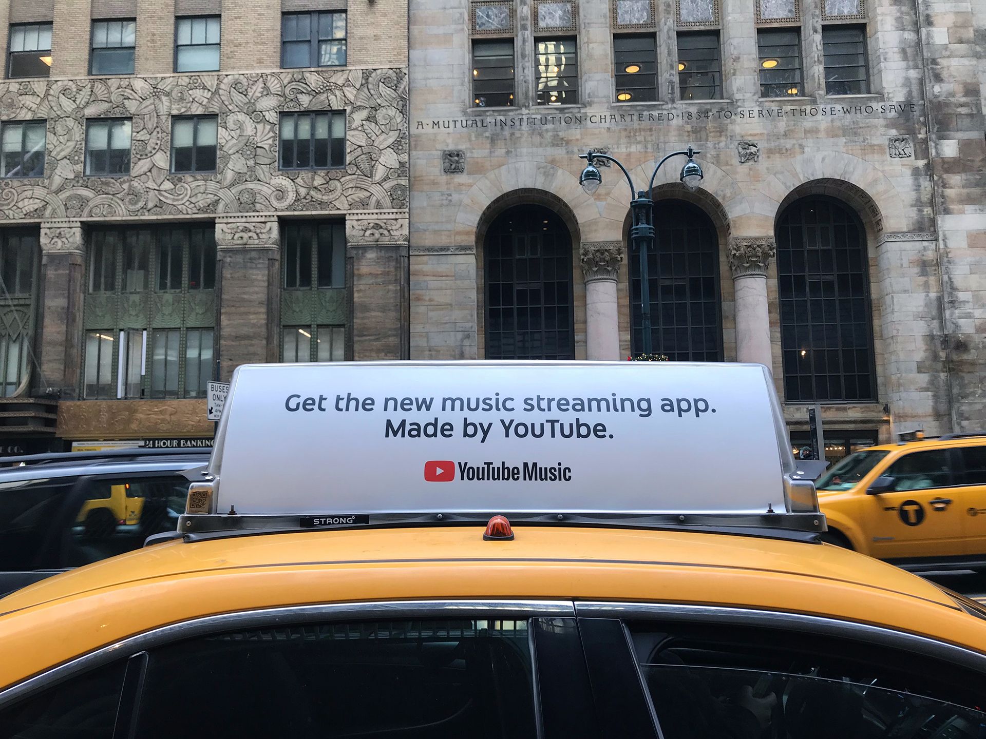 Ad on top of taxi says Get the new music streaming app.. Made by YouTube. YouTube Music