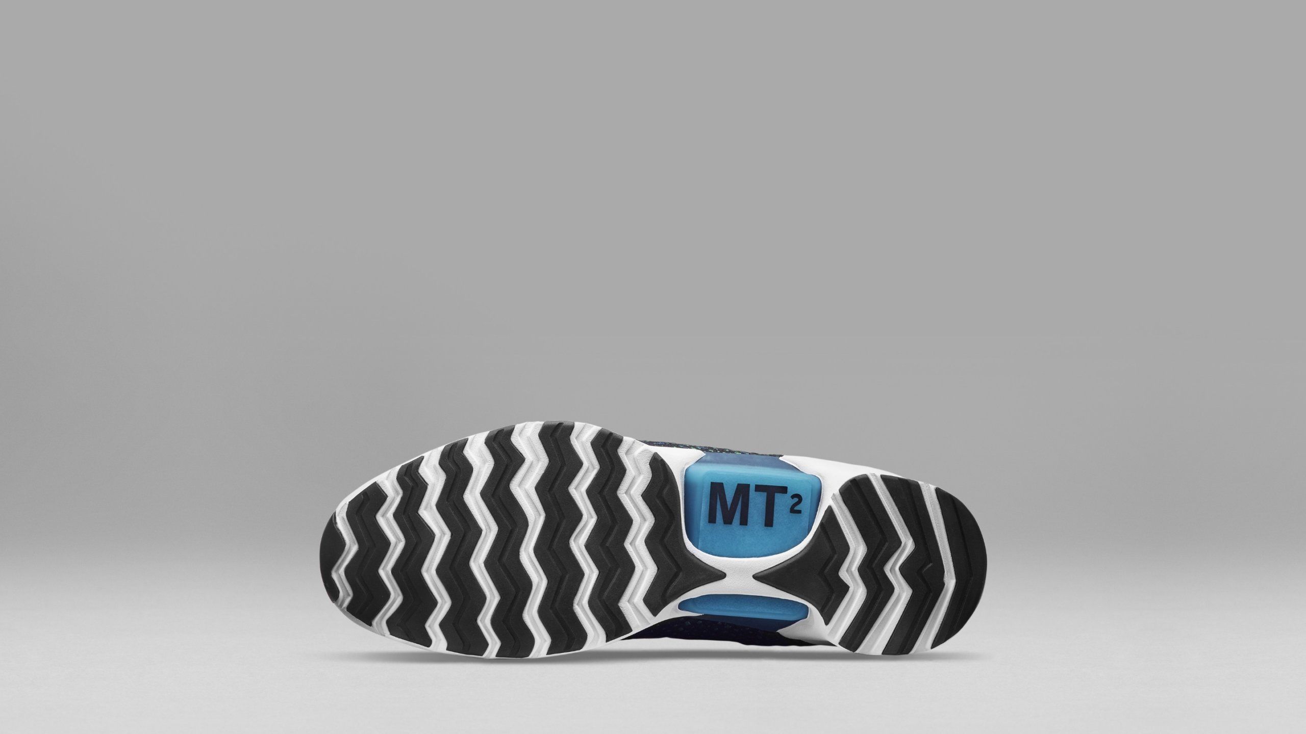 Bottom of Hyper Adapt sneaker showing black and white zig zag tread and MT2 light up arch piece