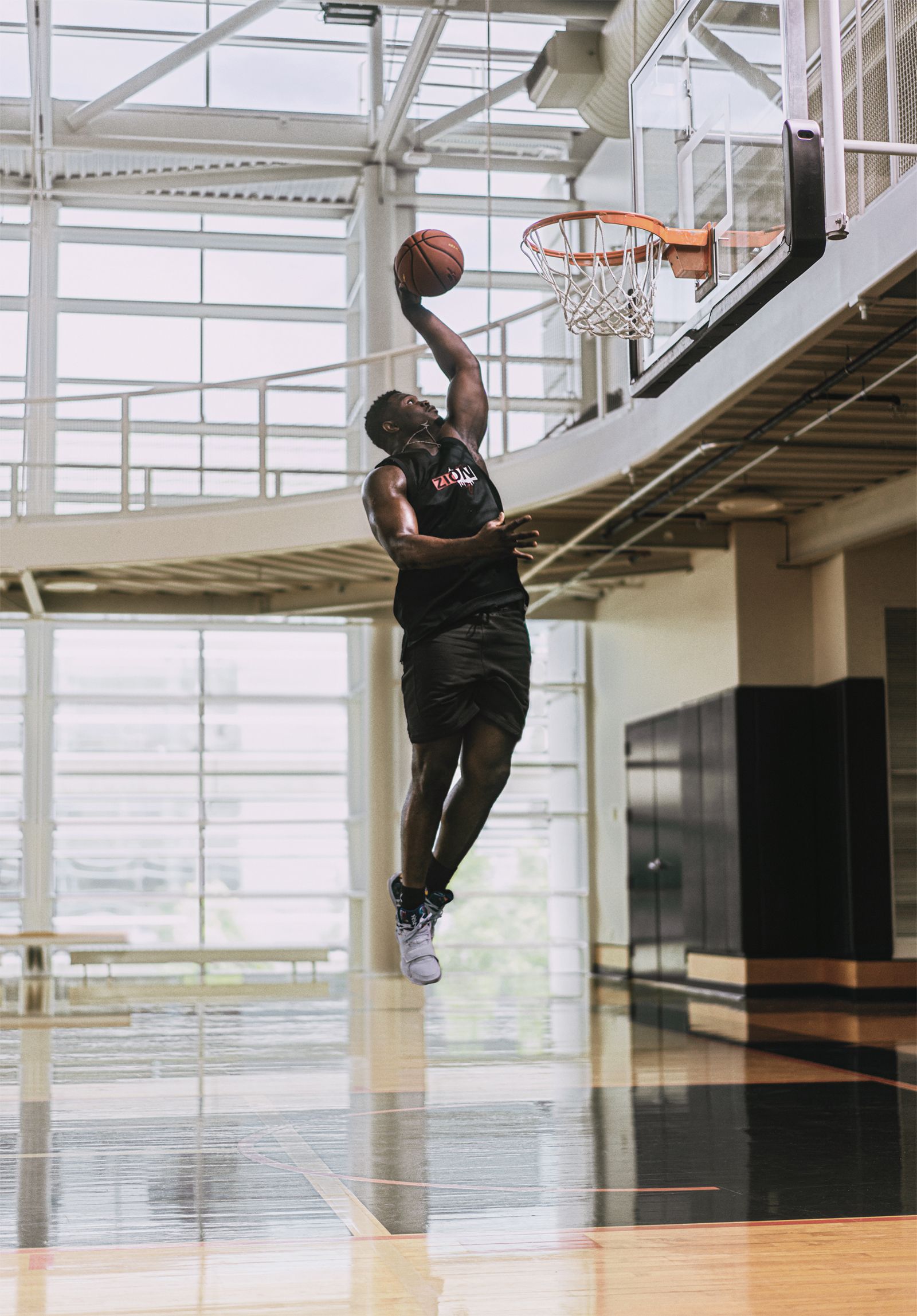 Zion Williamson mid air about to dunk basketball