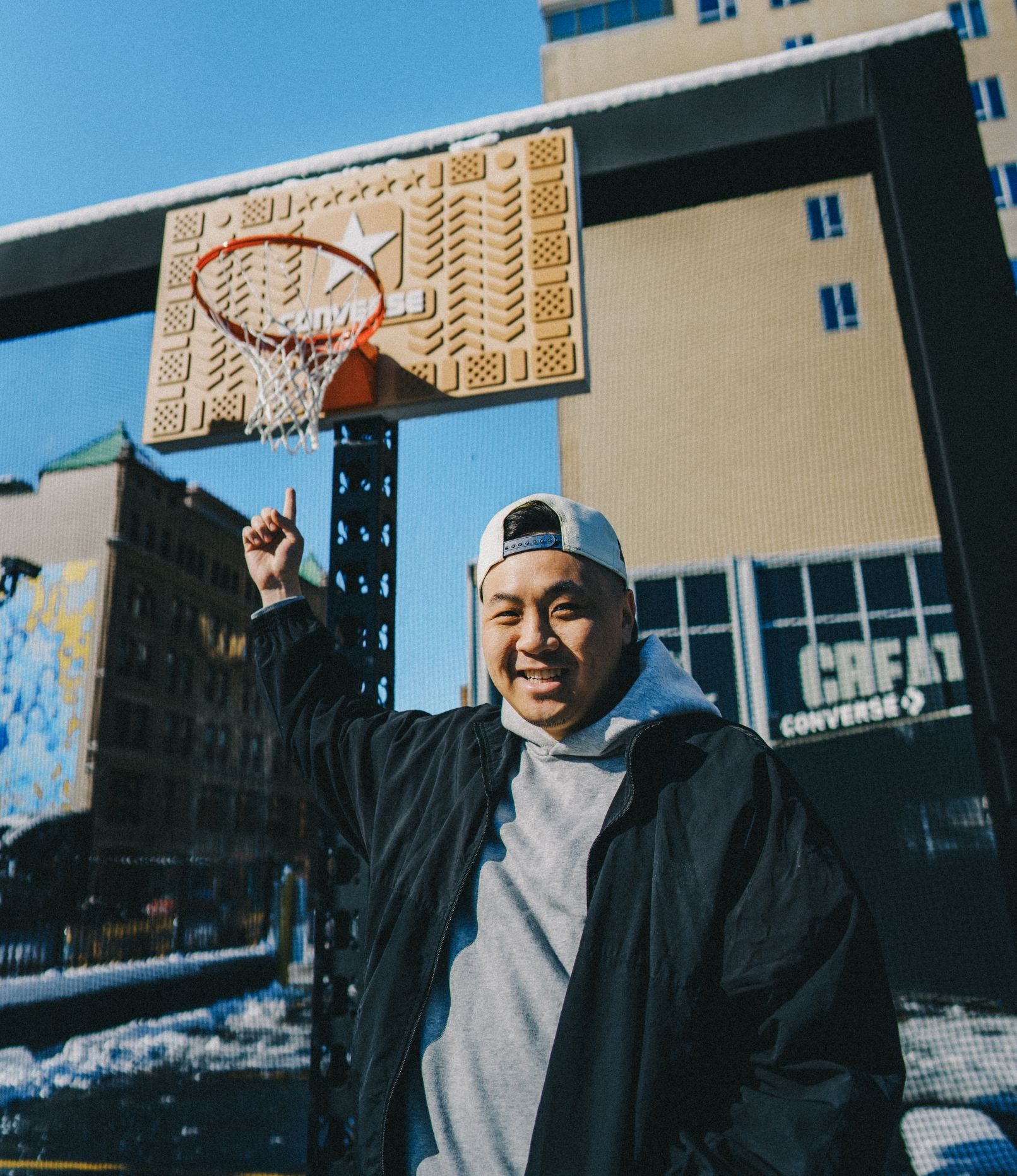 Artist, Kevin Concepts, points to his custom woodwork basketball backboard