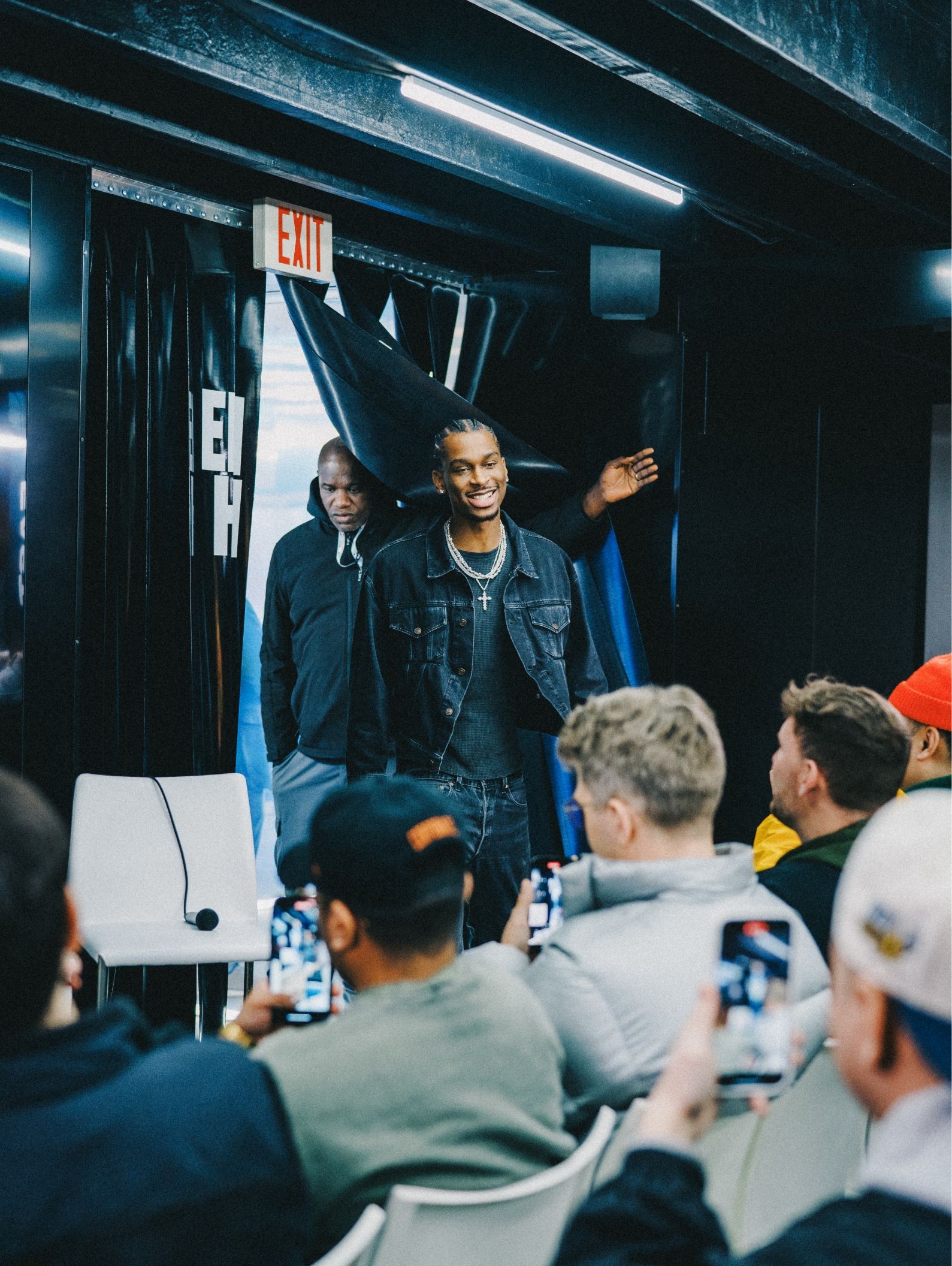 Shai Gilgeous-Alexander enters room with people seated