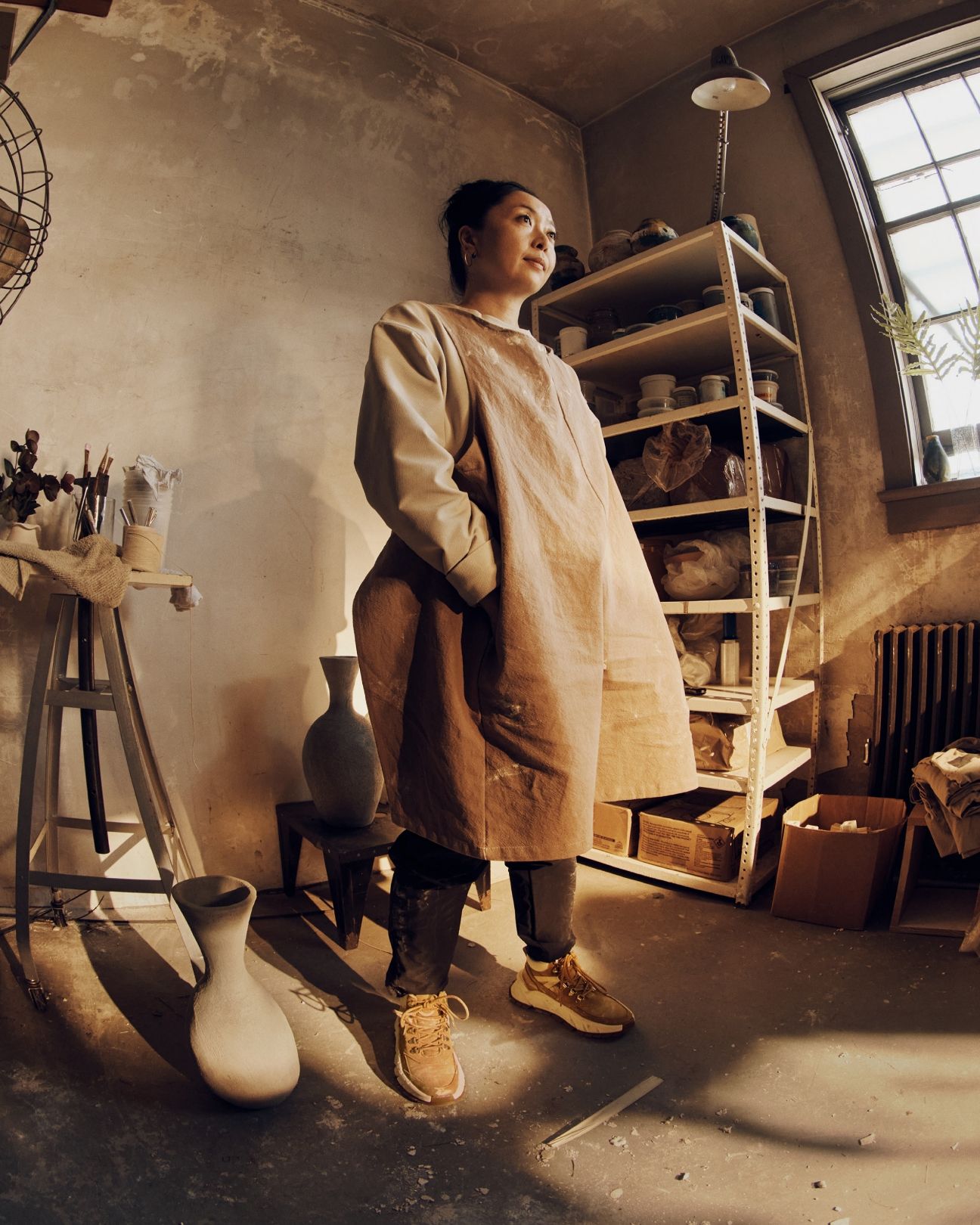 Shino standing in pottery studio.