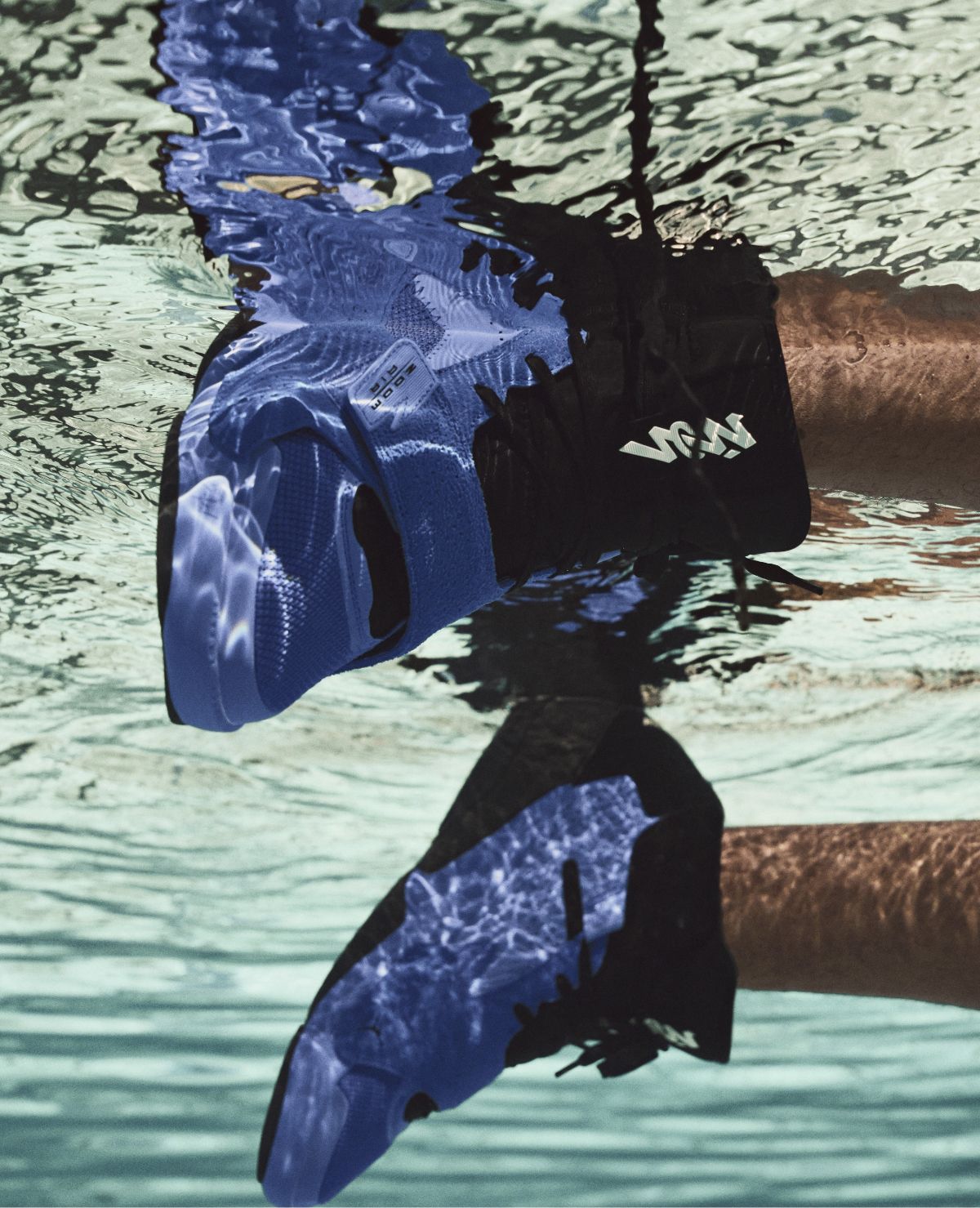 close up of Nike Zion 2 sneakers in blue being worn floating underwater in swimming pool