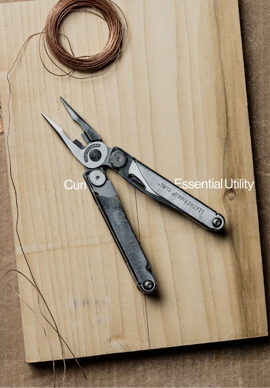 leatherman tool open on piece of wood with coil of copper wire