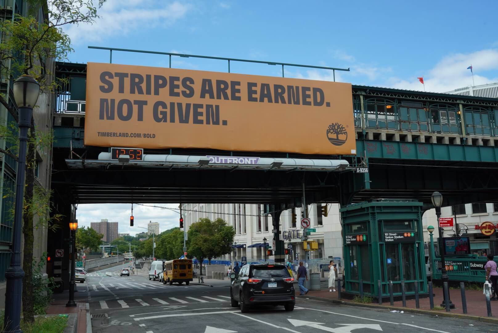 Stripes are earned not given billboard on city street overpass