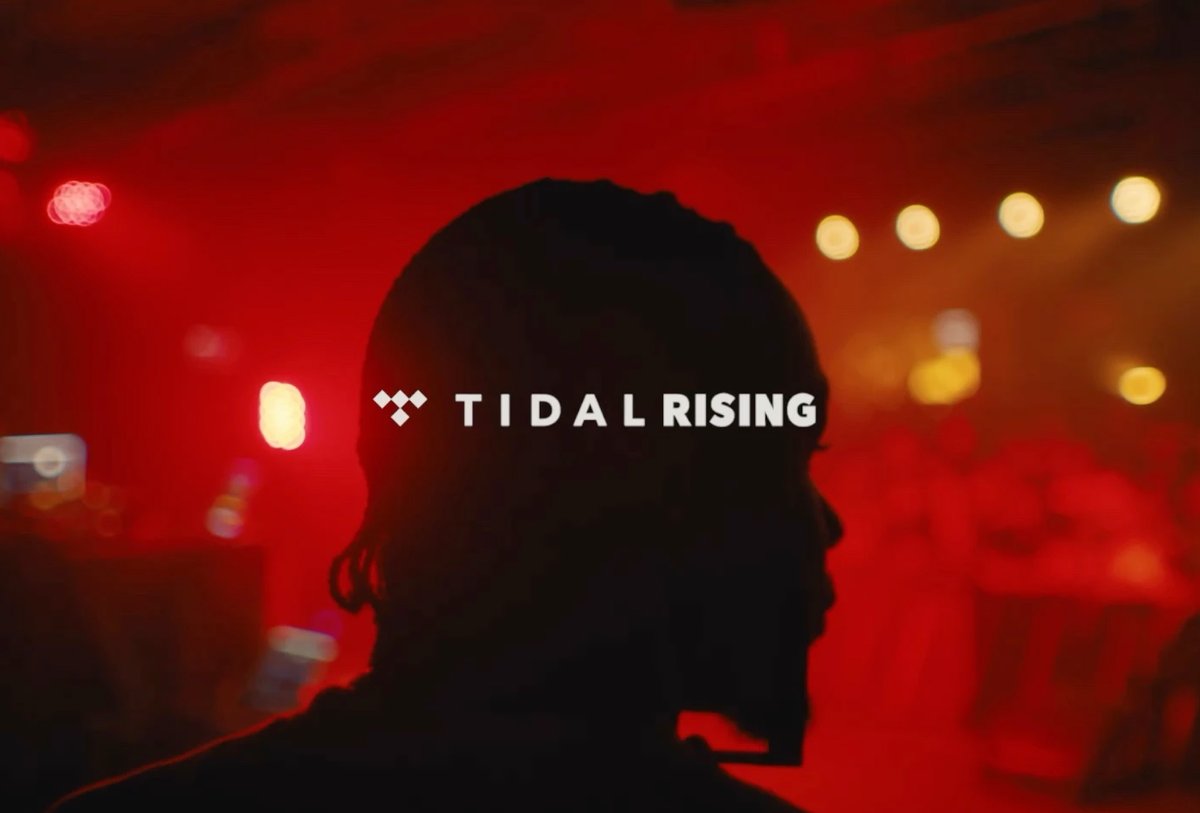 A silhouette of a person in front of red lighting with the text "TIDAL RISING" across the center.
