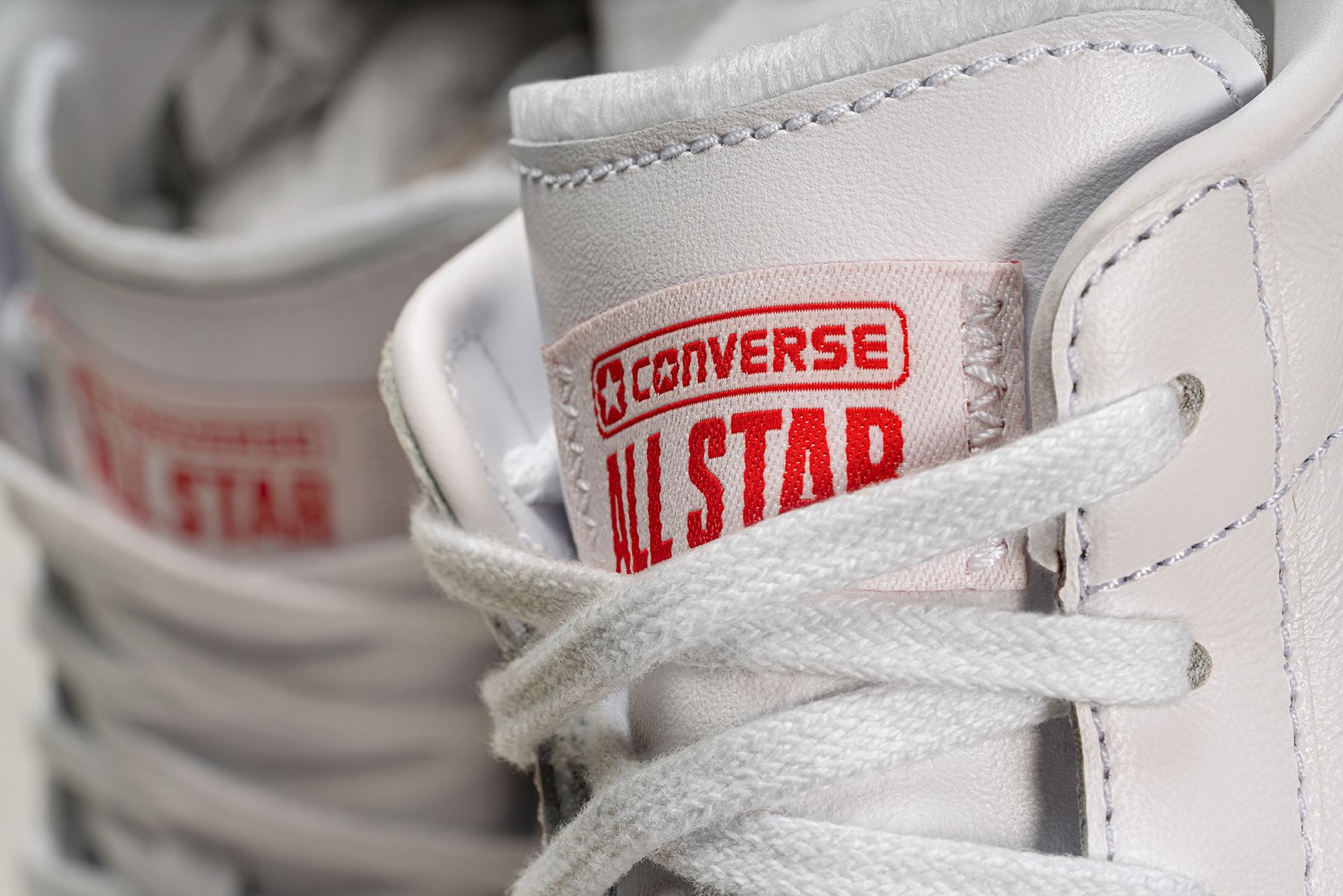 close up of tongue converse all star patch on shoes