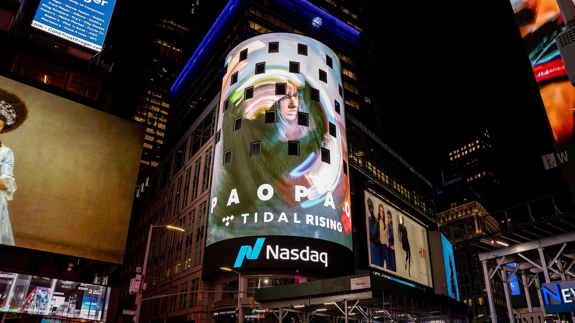 NYC Times Square video billboard showing artist Pao Pao with the text Pao Pao Tidal Rising