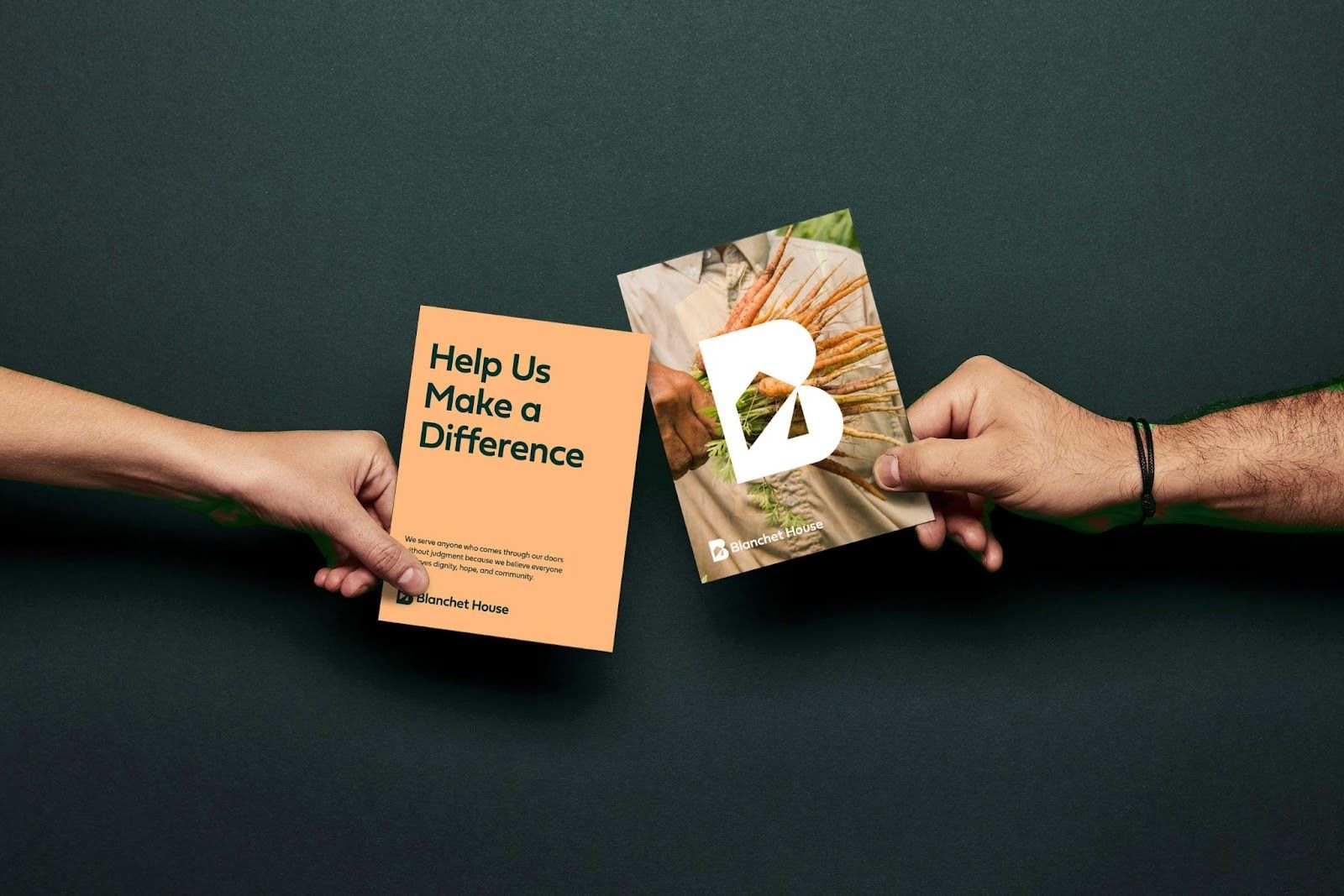 Hand holding Blanchet House Postcards. Read Help Us Make a Difference.